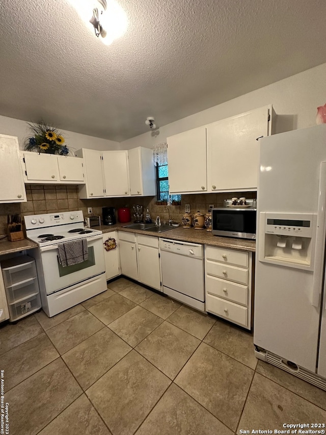 kitchen with white cabinets, white appliances, a textured ceiling, and sink