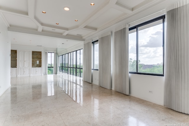 empty room with plenty of natural light, crown molding, coffered ceiling, and light tile flooring