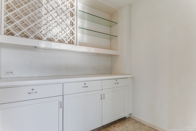 kitchen featuring white cabinets and light tile floors