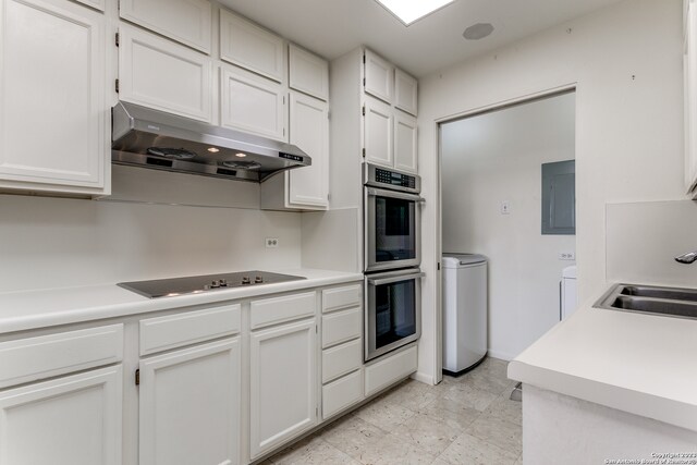 kitchen featuring white cabinets, black electric stovetop, and light tile flooring