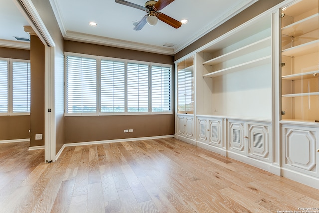 empty room featuring ceiling fan, ornamental molding, light hardwood / wood-style floors, and plenty of natural light