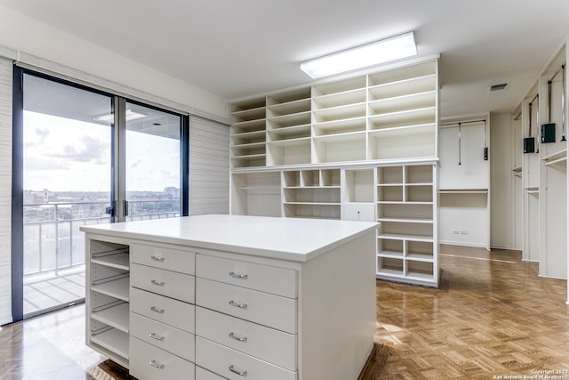 spacious closet with light parquet floors