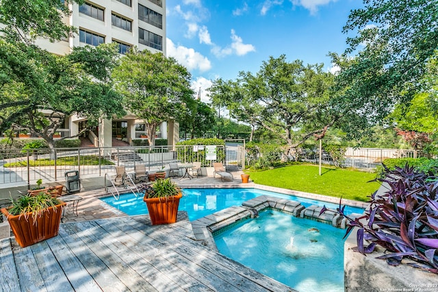 view of pool with a lawn, a patio, and an in ground hot tub