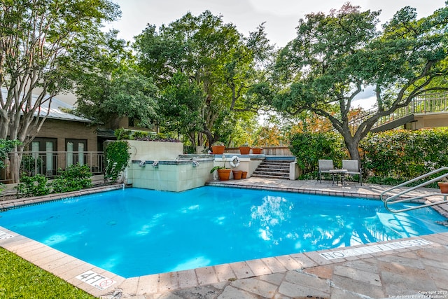 view of swimming pool with a patio