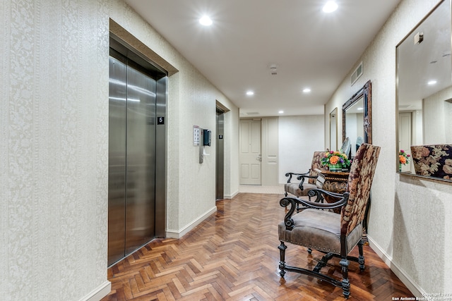 hallway with elevator and parquet floors