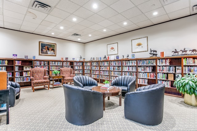 sitting room with light colored carpet and a drop ceiling