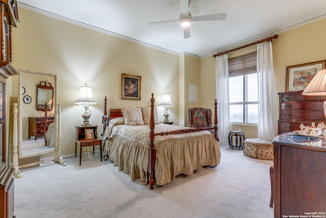 carpeted bedroom featuring ceiling fan and ornamental molding