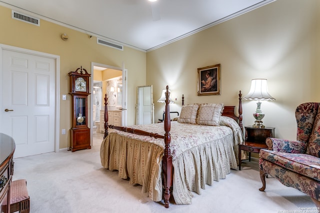 bedroom with ceiling fan, ensuite bath, ornamental molding, and light colored carpet