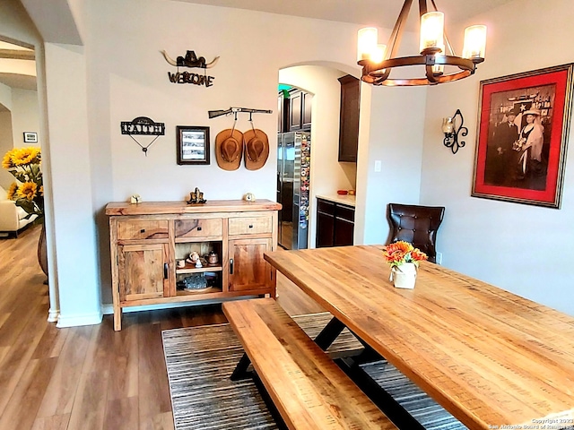 dining room with a chandelier and dark hardwood / wood-style floors