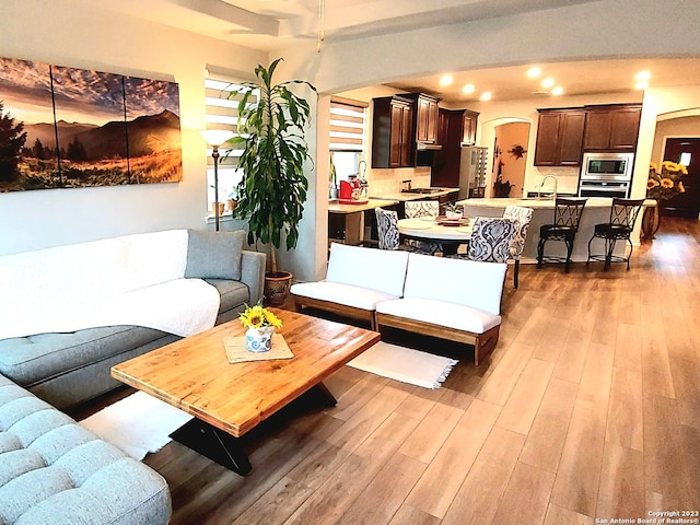 living room with sink and light hardwood / wood-style flooring