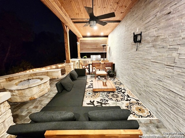 patio terrace at twilight with an outdoor hangout area and ceiling fan