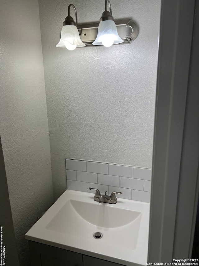 bathroom featuring backsplash and vanity