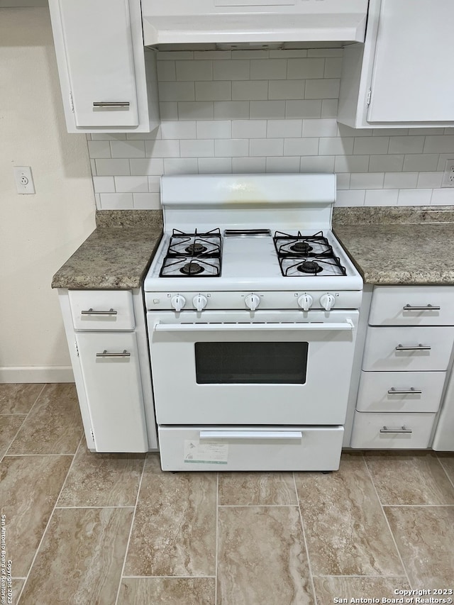 kitchen featuring custom range hood, tasteful backsplash, gas range gas stove, light tile floors, and white cabinetry