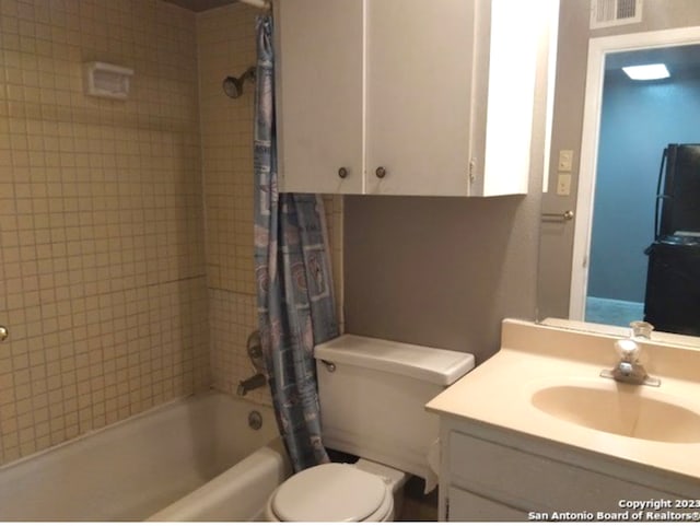 full bathroom featuring shower / bath combination with curtain, toilet, and vanity