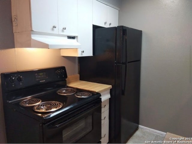 kitchen featuring light tile floors, white cabinets, electric range, and premium range hood