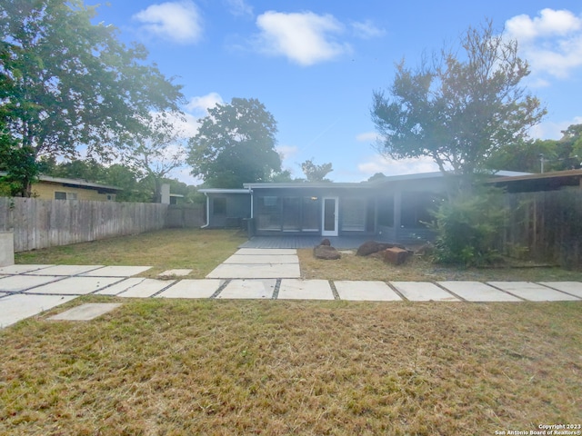 back of house with a lawn