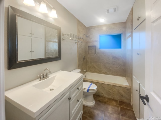 full bathroom with toilet, vanity, tile patterned floors, and tiled shower / bath