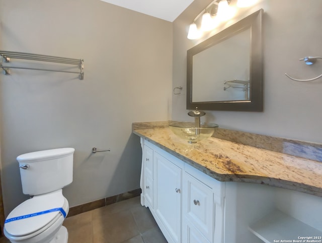 bathroom with tile patterned floors, vanity, and toilet