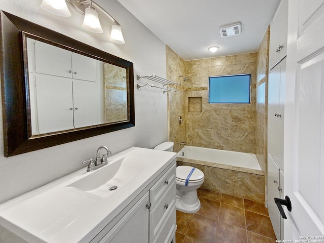 full bathroom with toilet, tile patterned flooring, vanity, and tiled shower / bath