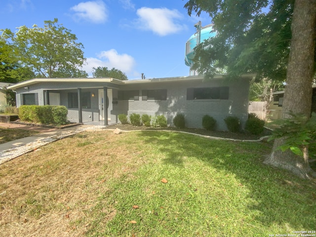 rear view of house with a lawn