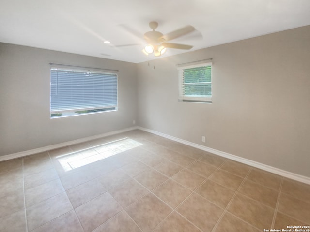 unfurnished room featuring ceiling fan and light tile patterned flooring