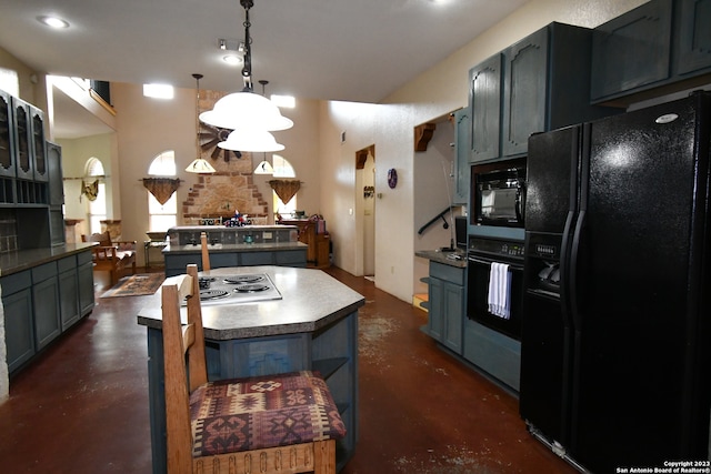 kitchen with a kitchen island, pendant lighting, a chandelier, and black appliances