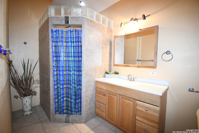 bathroom featuring tile walls, large vanity, and tile flooring