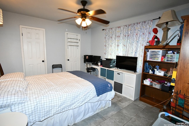 bedroom with ceiling fan and tile floors