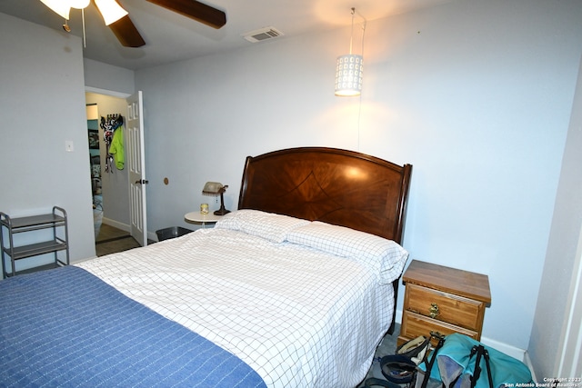 bedroom with ceiling fan and dark colored carpet