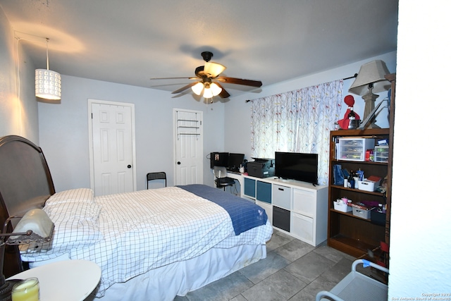 bedroom with ceiling fan and light tile floors