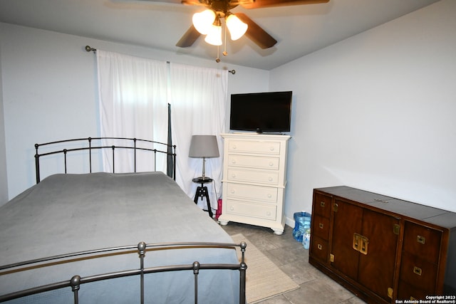 bedroom with ceiling fan and light tile floors