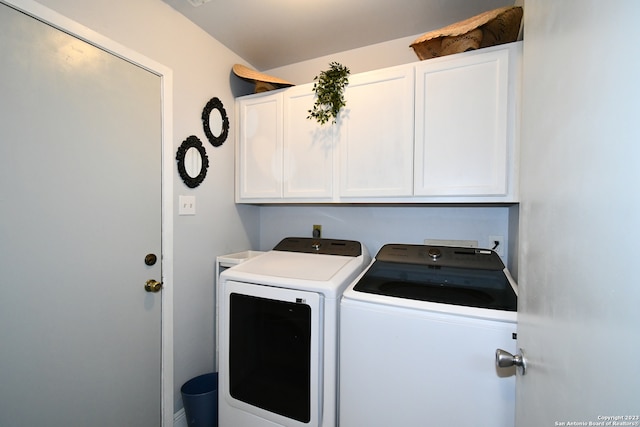 laundry room with cabinets and washing machine and dryer