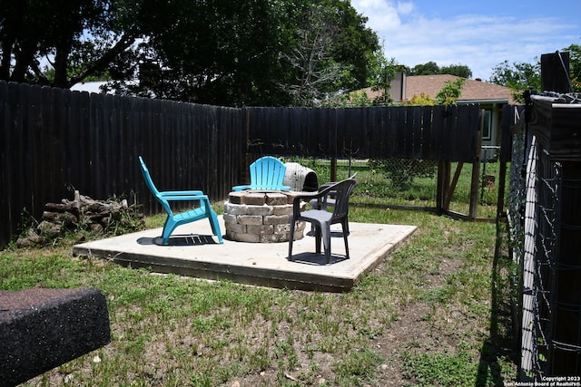 view of yard featuring an outdoor fire pit and a patio area