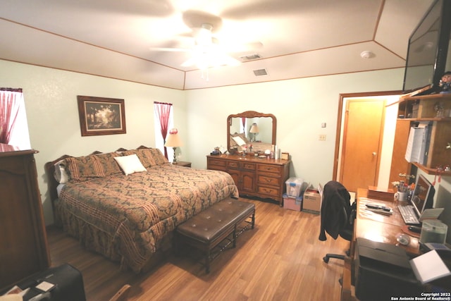 bedroom with light hardwood / wood-style floors and ceiling fan