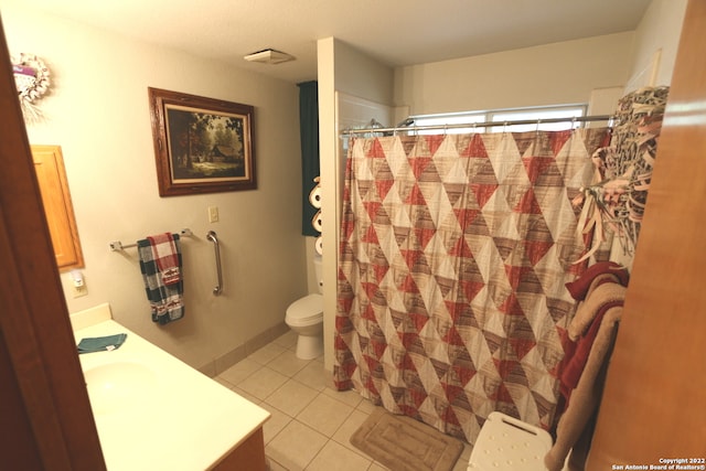 bathroom with toilet, tile floors, and vanity