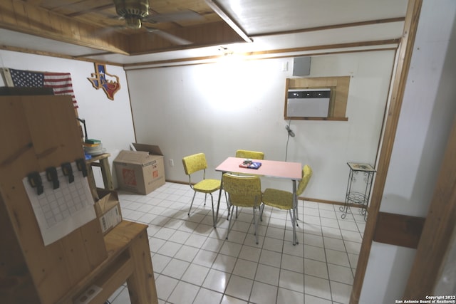 tiled dining room featuring wood ceiling and ceiling fan