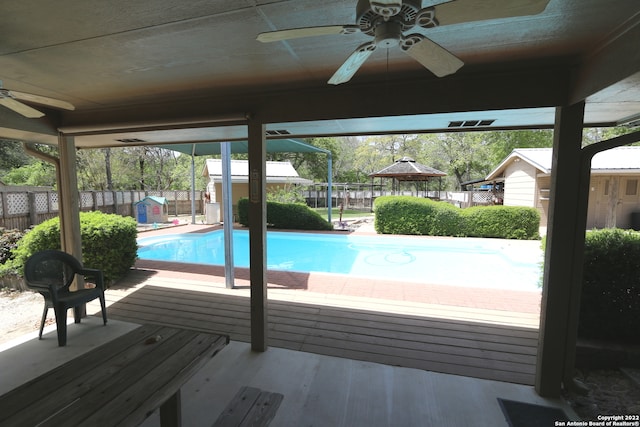 view of swimming pool featuring ceiling fan, a gazebo, and a patio