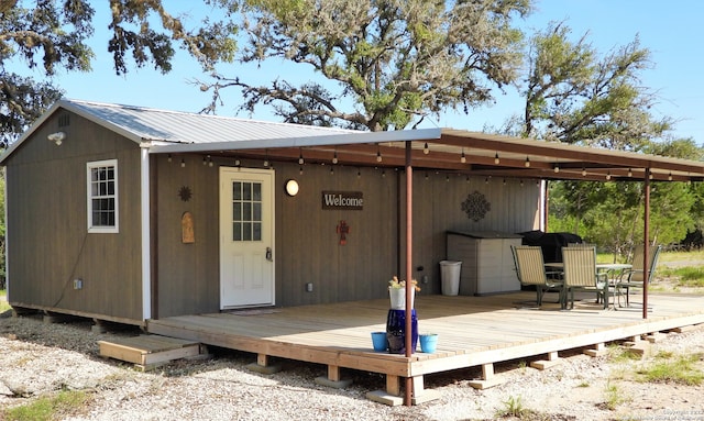 rear view of property featuring a wooden deck