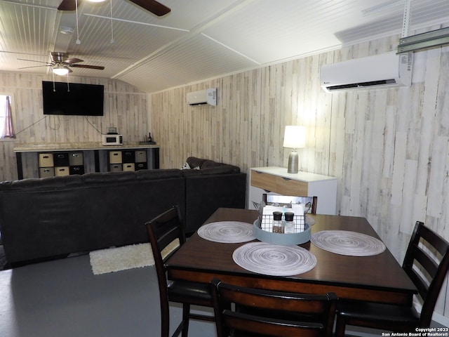 dining space featuring wood walls, a wall mounted air conditioner, vaulted ceiling, and ceiling fan