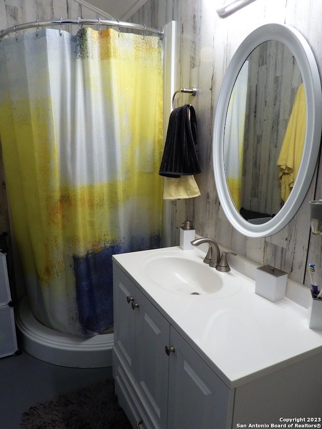 bathroom with wood walls and large vanity