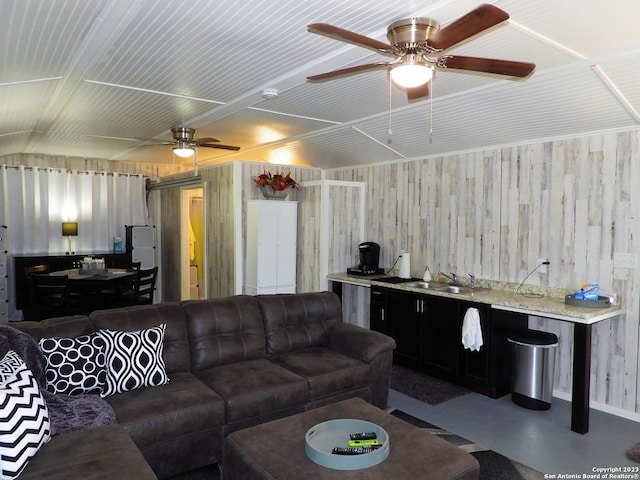 living room with lofted ceiling, ceiling fan, and sink