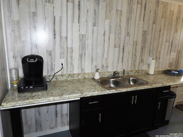 kitchen with wood walls and sink