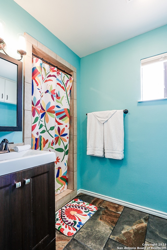 bathroom featuring tile floors and vanity