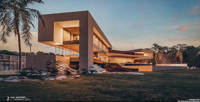 back house at dusk with a balcony