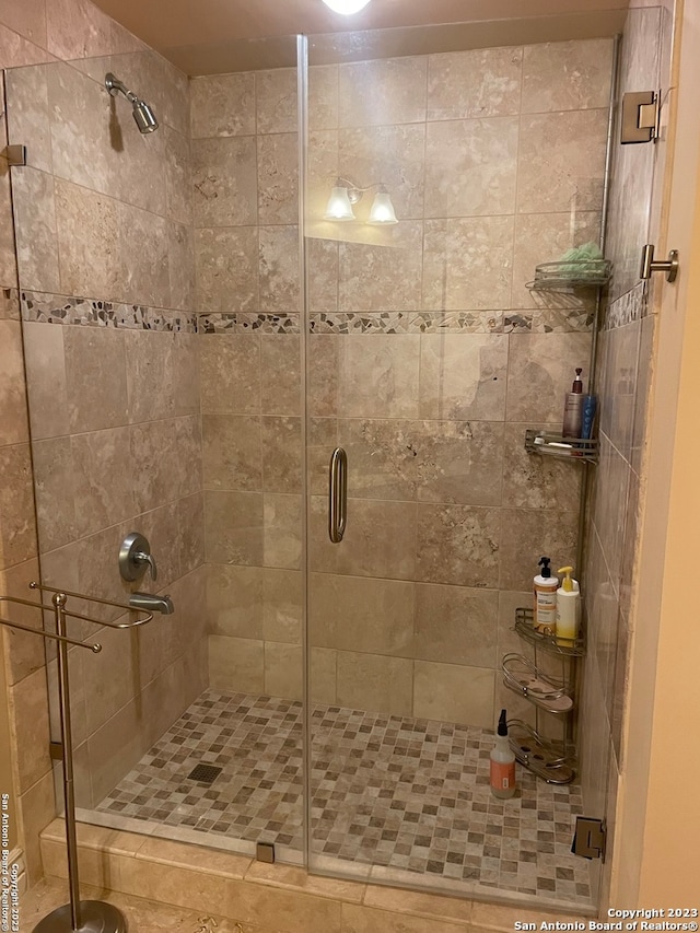 bathroom with a shower with shower door