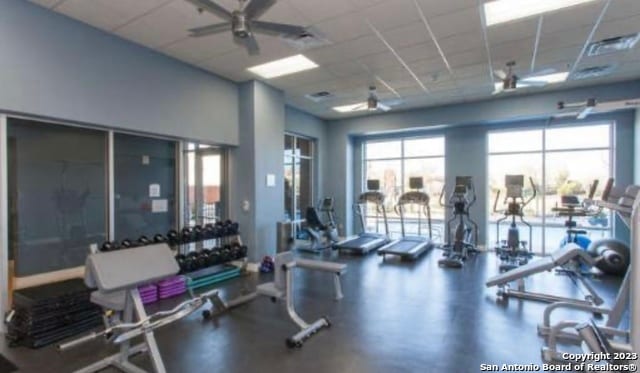 gym featuring a paneled ceiling and ceiling fan