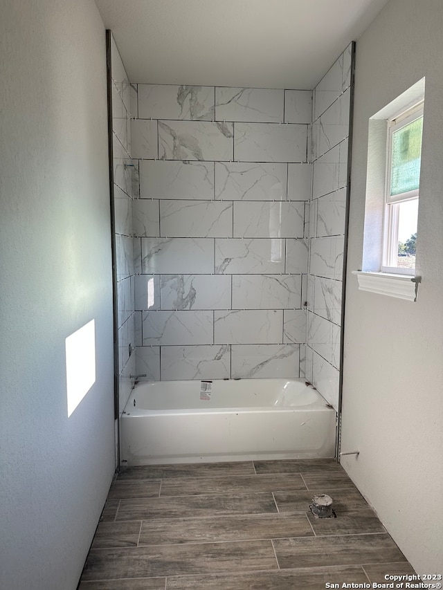 bathroom with tile patterned flooring and tiled shower / bath combo