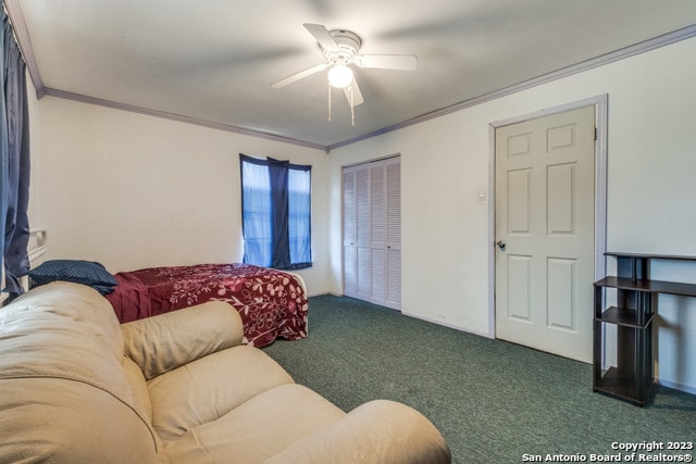 carpeted living room with ceiling fan and ornamental molding