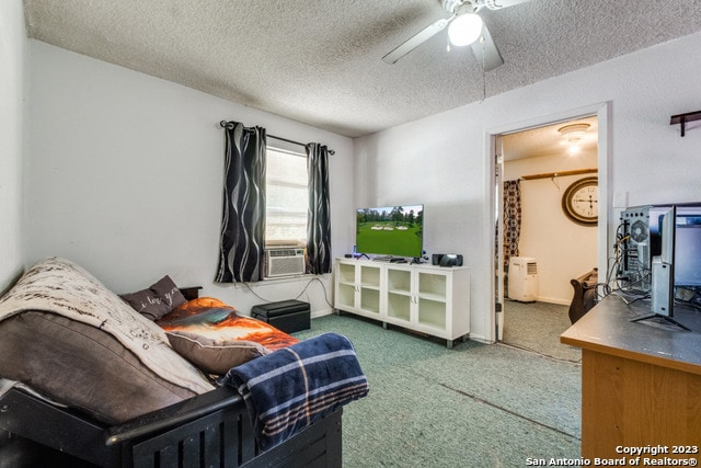 bedroom with dark carpet, ceiling fan, and a textured ceiling