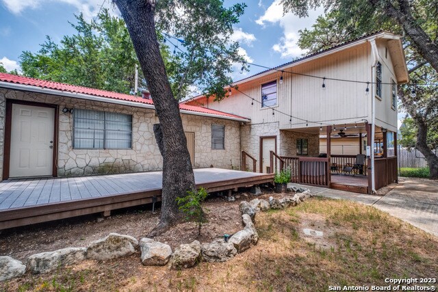 back of house featuring a wooden deck